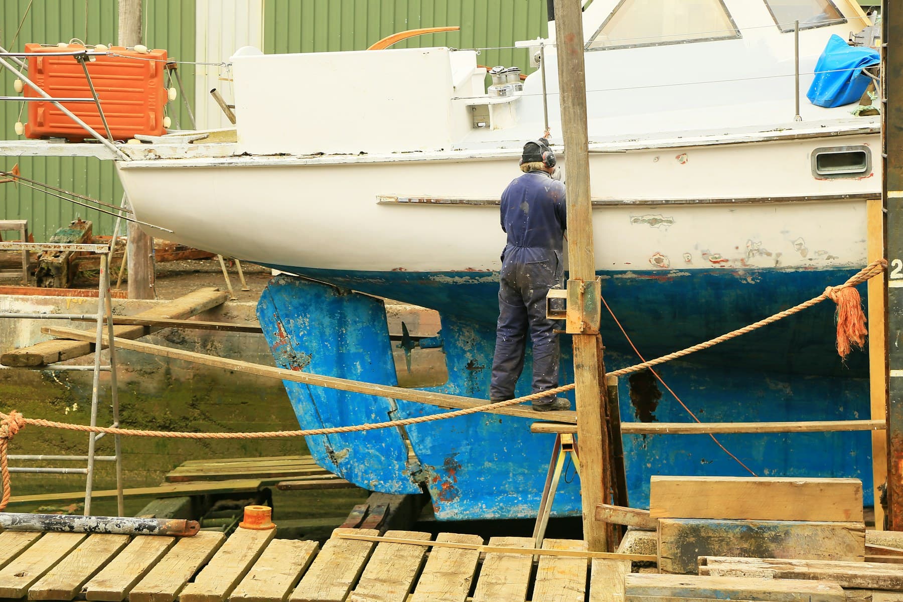 Marine mechanic working on a boat at a dock